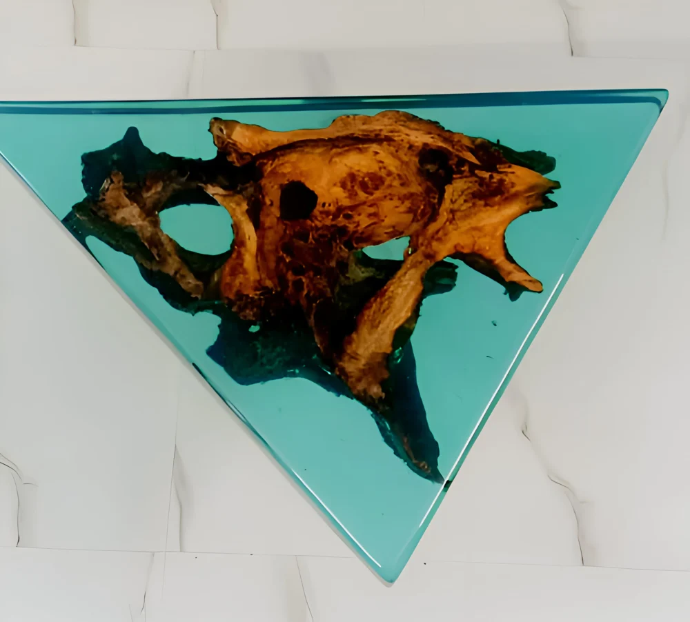 This stunning resin wall art piece showcases a unique fusion of natural wood and vibrant aqua-blue resin, beautifully encapsulated in a sleek triangular frame