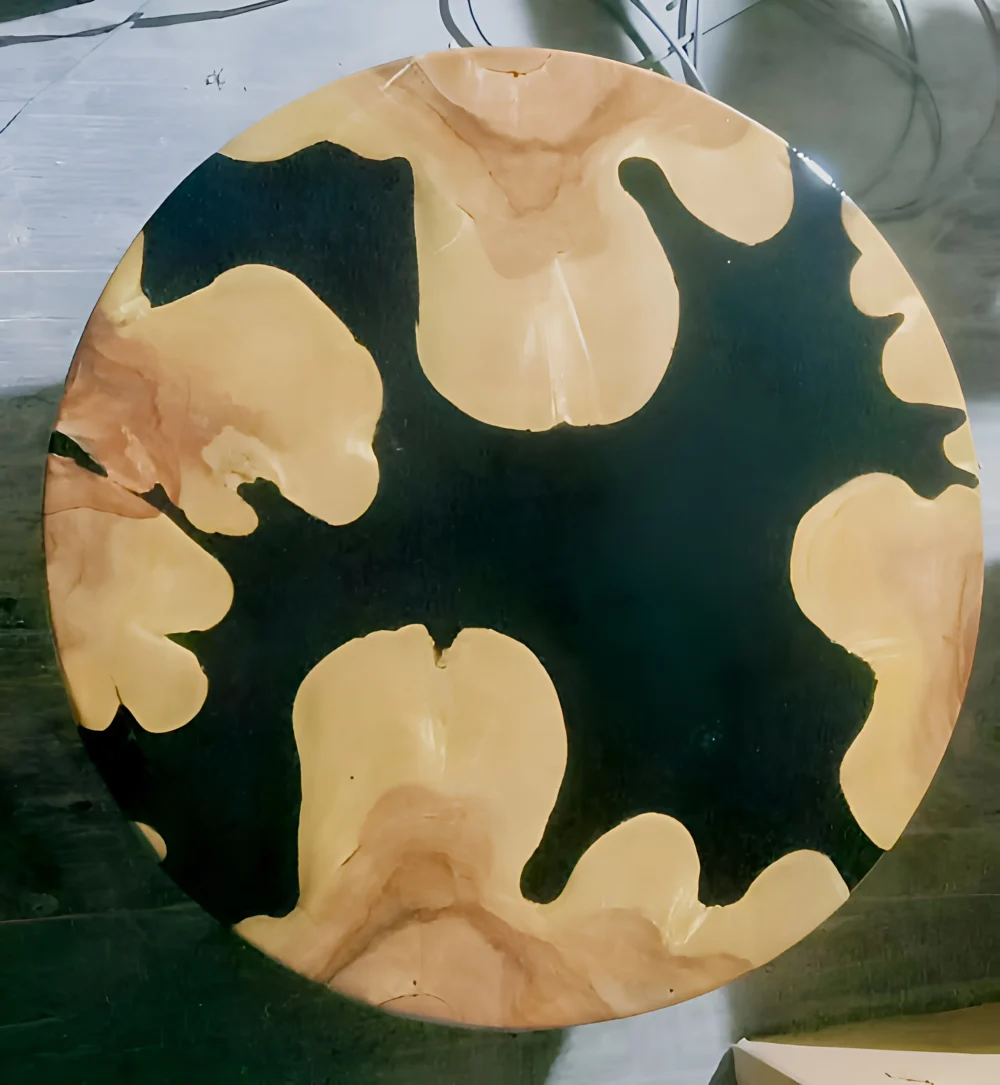 a striking round resin coffee table with a bold and artistic design