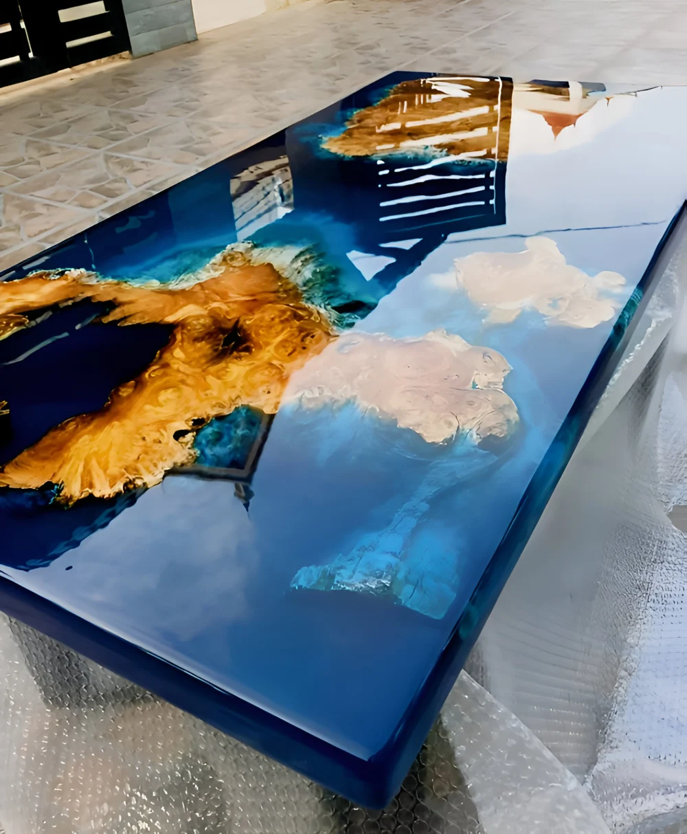 a stunning custom resin dining table with a striking blend of natural wood and deep oceanic blue epoxy resin