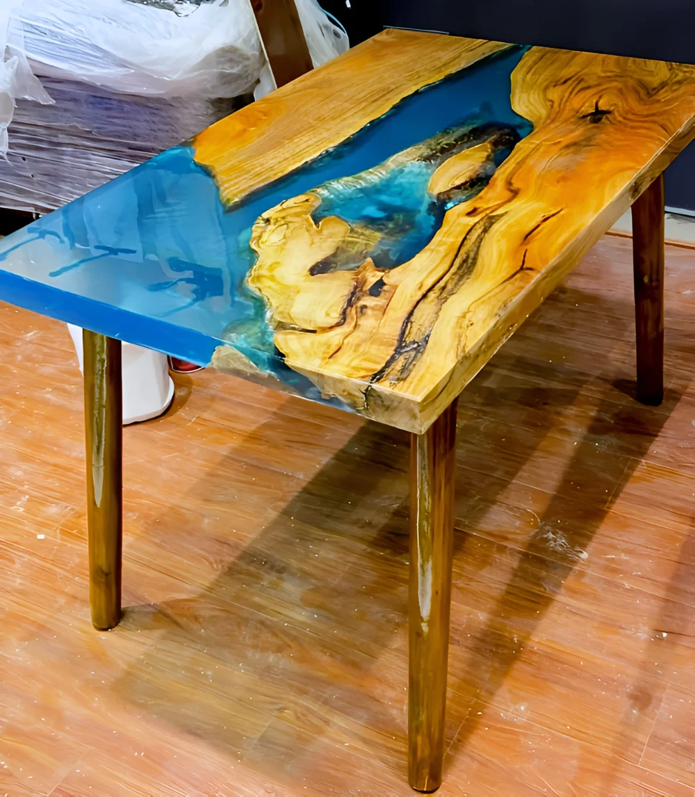 This captivating resin dining table showcases a perfect harmony between natural wood and deep blue resin, creating a stunning river-inspired design